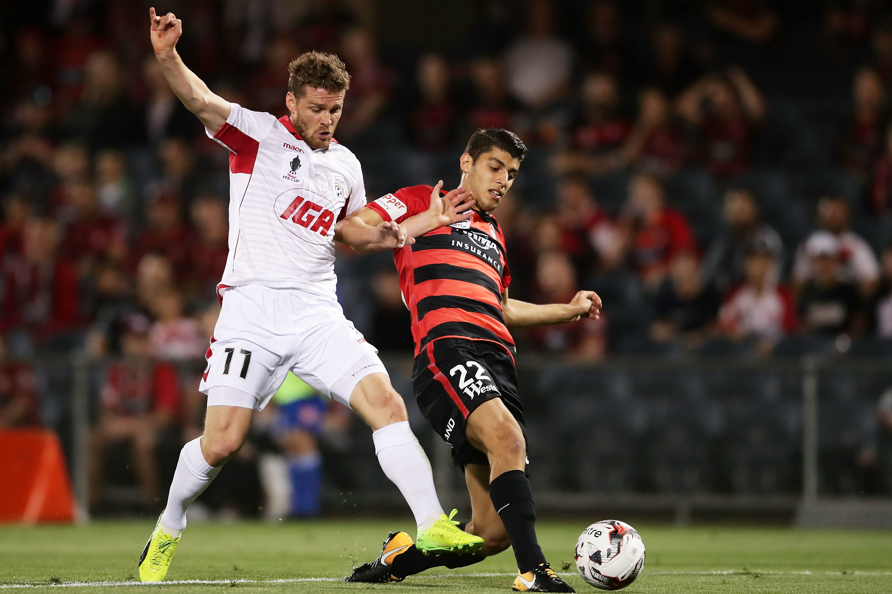 Johan Absalonsen gets in a tangle with Wanderers defender Jonathan Aspropotamitis.