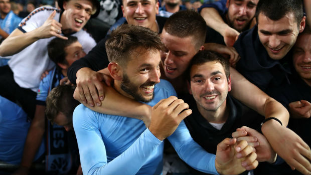 Milos Ninkovic is swamped by Sky Blues fans after full-time in the Sydney Derby.