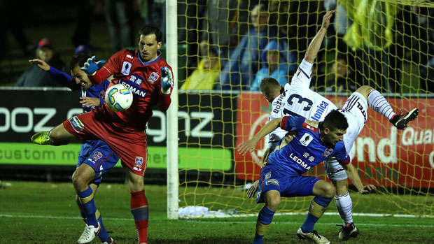 Jets keeper Ben Kennedy comes out to claim a cross from Melbourne Victory in their FFA Cup clash.