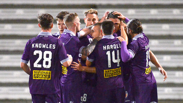 Perth Glory players celebrate one of their two first half goals against Brisbane Roar.