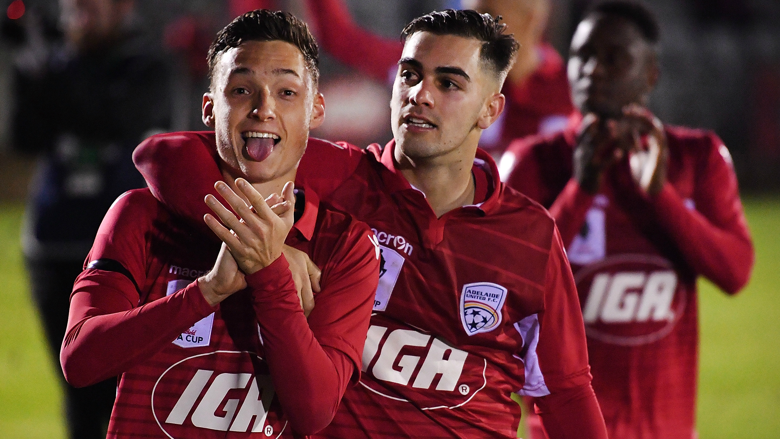 Adelaide United players Jordan O'Doherty and Ben Garuccio thank the fans after their win over Melbourne Victory.