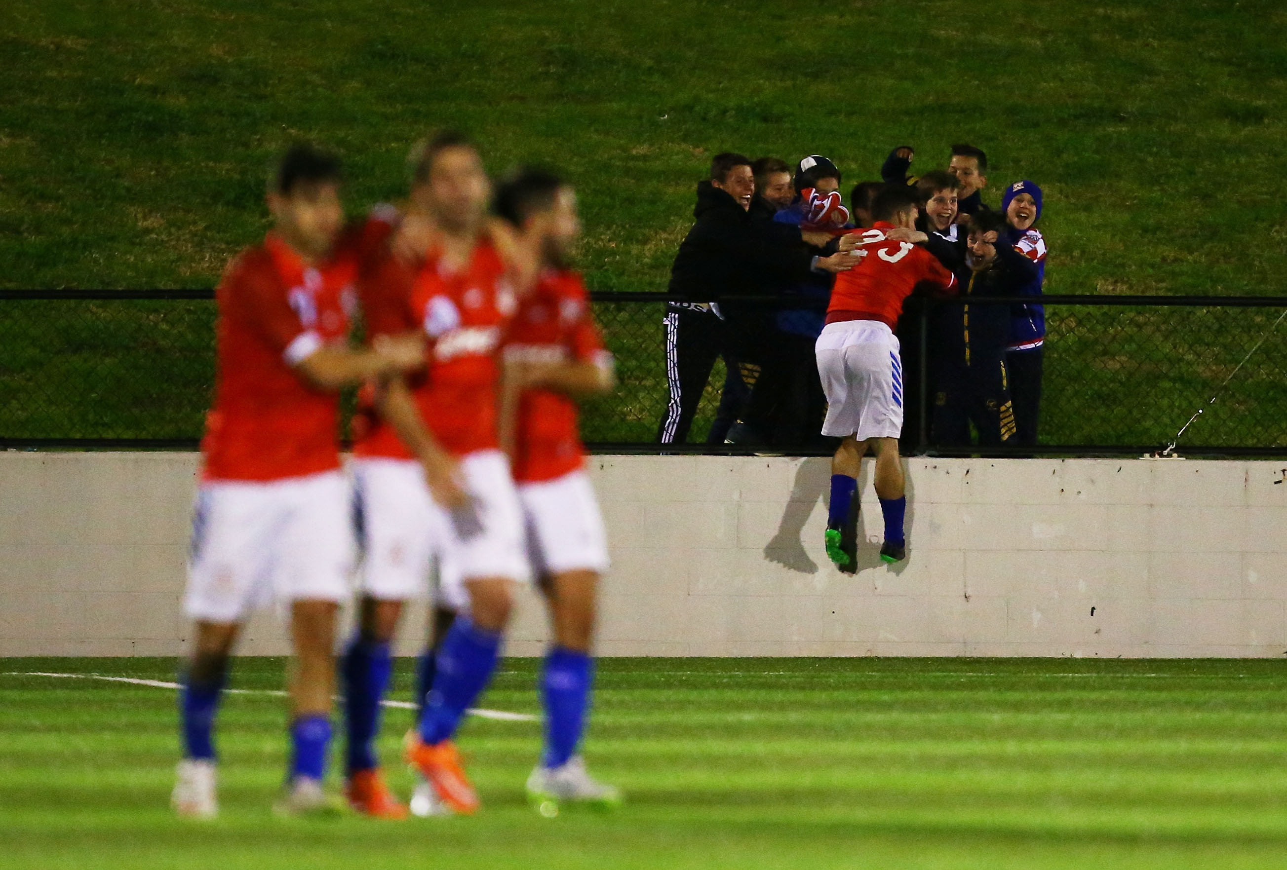 Panagiotis Nikas of Sydney United celebrates with young fans after scoring their second goal.