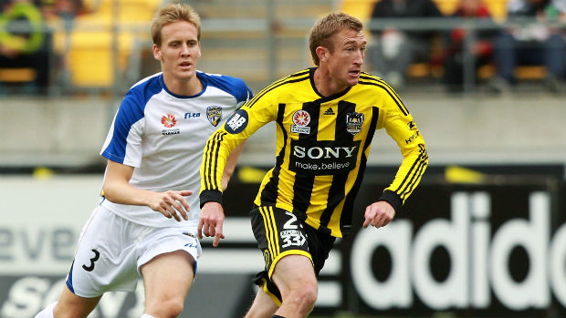 Former Phoenix star Alex Smith in 2012 action against Michael Thwaite of Gold Coast United.